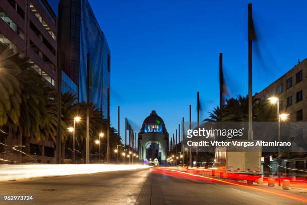 ligh trails at the monument of the revolution during blue hour. mexico city. - revolution monument stock pictures, royalty-free photos & images