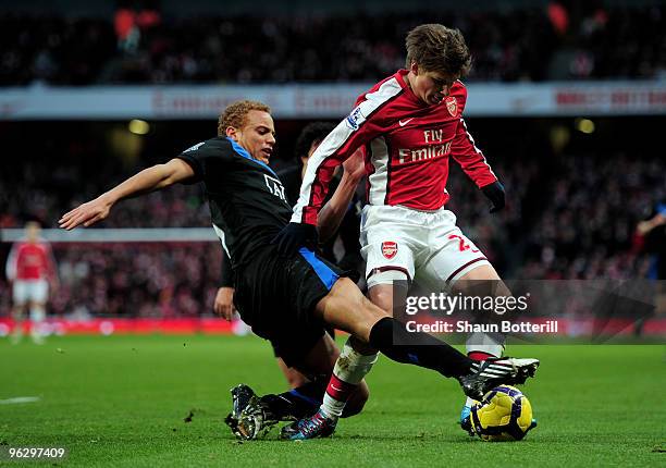 Andrei Arshavin of Arsenal is tackled by Wes Brown of Manchester United during the Barclays Premier League match between Arsenal and Manchester...