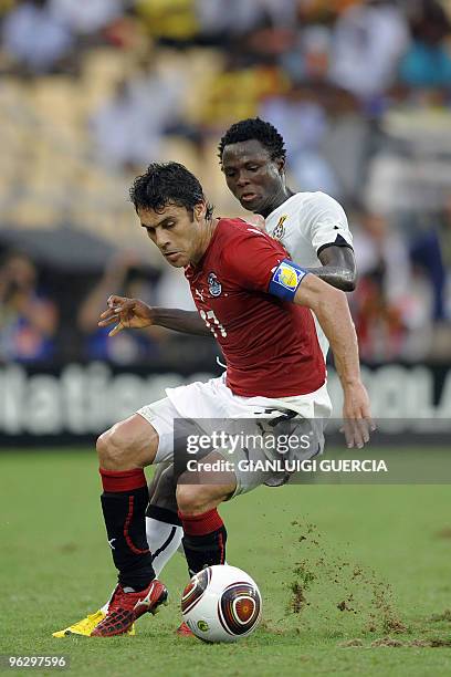 Kamel Ahmed Hassan of Egypt prevents Samuel Inkoom of Ghana from breaking trough during their final match of the African Cup of Nations CAN2010 at...