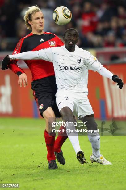 Sami Hyypiae of Leverkusen tackles Papiss Demba Cissé of Freiburg during the Bundesliga match between Bayer Leverkusen and SC Freiburg at the...