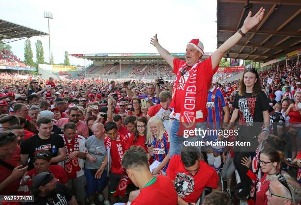 Supporters of Cottbus celebrate after their team moving up into the third league after the Third League Playoff Leg 2 match between FC Energie...