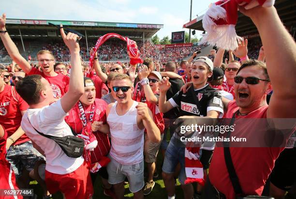 Supporters of Cottbus celebrate after their team moving up into the third league after the Third League Playoff Leg 2 match between FC Energie...