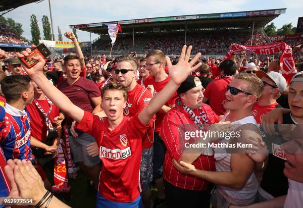 Supporters of Cottbus celebrate after their team moving up into the third league after the Third League Playoff Leg 2 match between FC Energie...