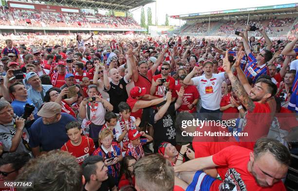 Supporters of Cottbus celebrate after their team moving up into the third league after the Third League Playoff Leg 2 match between FC Energie...