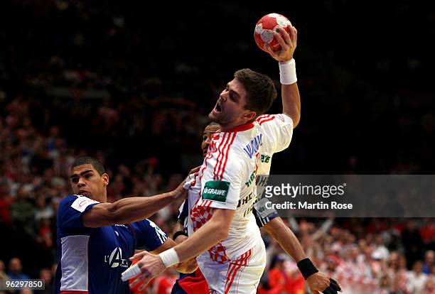 Daniel Narcisse of France in action with Drago Vukovic of Croatia during the Men's Handball European final match between France and Croatia at the...