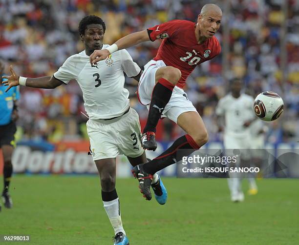 Egypt National football team player Gomaa Wael vies for the ball with Ghana's Gyan Asamoah on January 31, 2010 at the November 11 stadium in Luanda...