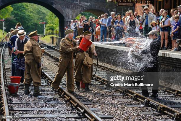 Volunteers from the Dad's Army Museum in Thetford attend a fire on the track at Weybourne Railway Station on May 27, 2018 in Weybourne, England. The...