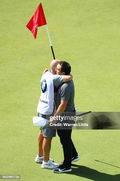 Francesco Molinari of Italy celebrates victory on the 18th green with his caddie during day four and the final round of the BMW PGA Championship at...