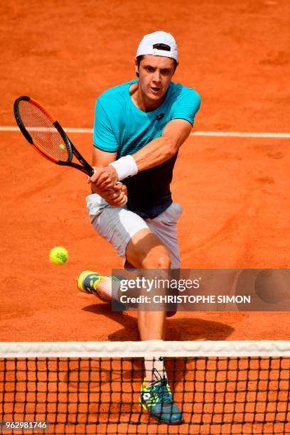 France's Maxime Janvier plays a backhand return to Japan's Kei Nishikori during their men's singles first round match on day one of The Roland Garros...