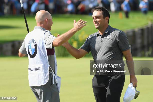 Francesco Molinari of Italy celebrates victory with his caddie on the 18th green during the final round of the BMW PGA Championship at Wentworth on...