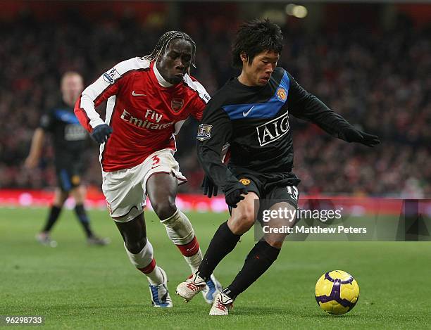 Ji-Sung Park of Manchester United clashes with Bakari Sagna of Arsenal during the FA Barclays Premier League match between Arsenal and Manchester...