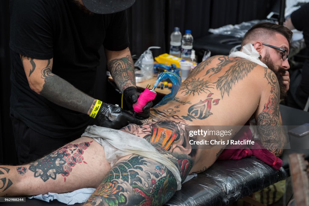 A man has a tattoo applied to his buttocks during the Great British... News  Photo - Getty Images