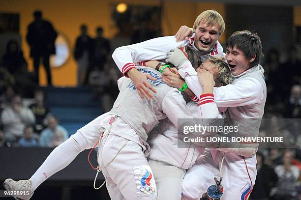 Team Russia celebrates on the podium after winning the Men's International Paris' Challenge Epee competition, on January 31, 2010. AFP PHOTO/LIONEL...