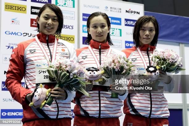 Winner Kanako Watanabe of Japan celebrates with runner-up Satomi Suzuki of Japan and third-placed Reona Aoki of Japan after the Women's 200m...
