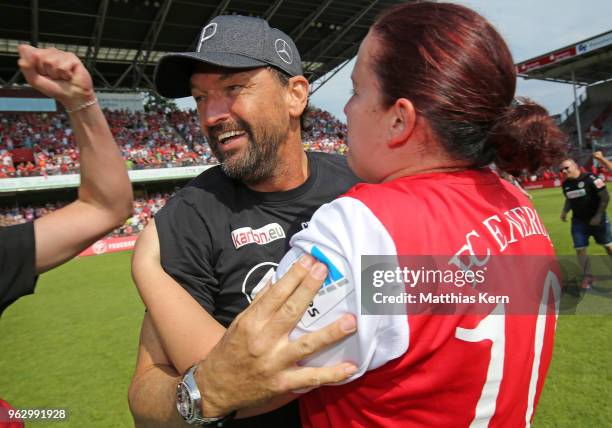 Head coach Claus Dieter Wollitz of Cottbus celebrates with supporters after moving up into the third league after the Third League Playoff Leg 2...