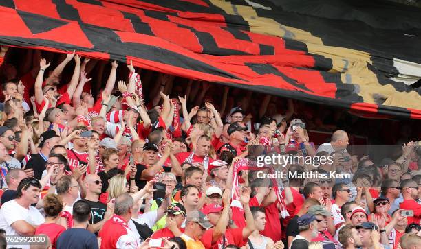 Supporters of Cottbus celebrate after their team moving up into the third league after the Third League Playoff Leg 2 match between FC Energie...