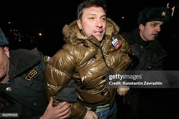 Police officers detain former First Deputy Prime Minister Boris Nemtsov, leader of the opposition group Solidarity, during an unauthorized...