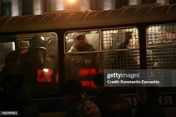 Opposition activists who were detained during an unauthorized anti-Kremlin protest are seen in a police bus before going to the police station...