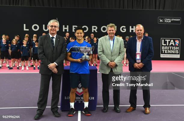 Hiroki Moriya of Japan poses with the Loughborough Trophy after winning the Mens Singles Final with Professor Chris Linton, Provost and Deputy Vice...
