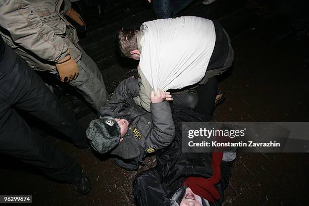 Police officers detain an opposition activist during an unauthorized anti-Kremlin protest January 31, 2010 in downtown Moscow, Russia. Several...