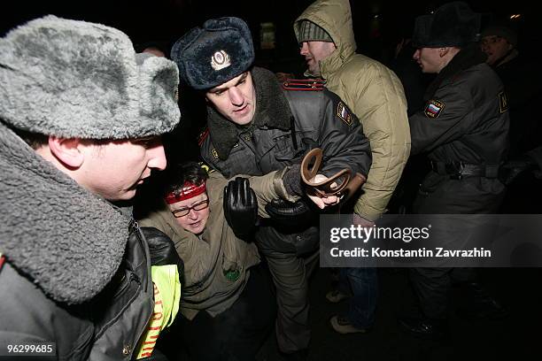 Police officers detain a disabled opposition activist during an unauthorized anti-Kremlin protest January 31, 2010 in downtown Moscow, Russia....