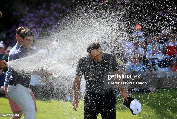 Francesco Molinari of Italy is sprayed with champagne by Matteo Manassero and fellow Italian players after his two stroke victory during the final...