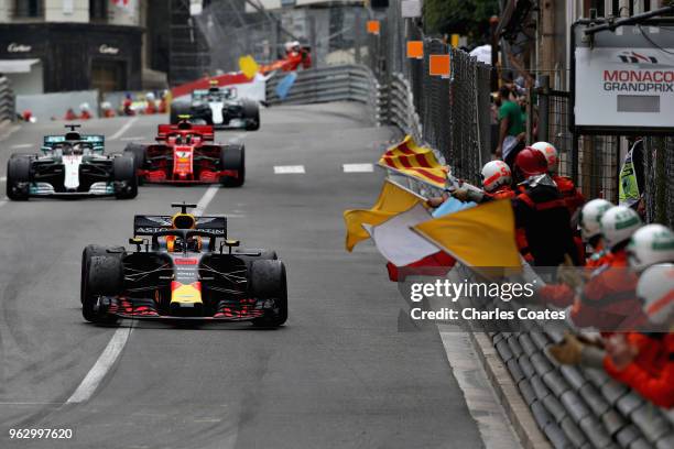 Race winner Daniel Ricciardo of Australia driving the Aston Martin Red Bull Racing RB14 TAG Heuer is greeted by flag waving marshals during the...