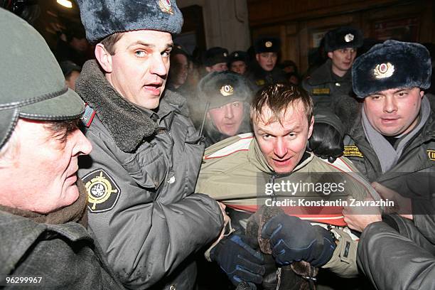 Police officers detain an opposition activist during an unauthorized anti-Kremlin protest January 31, 2010 in downtown Moscow, Russia. Several...