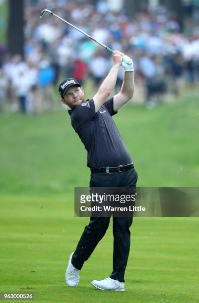 Branden Grace of South Africa plays a shot from the fairway during day four and the final round of the BMW PGA Championship at Wentworth on May 27,...