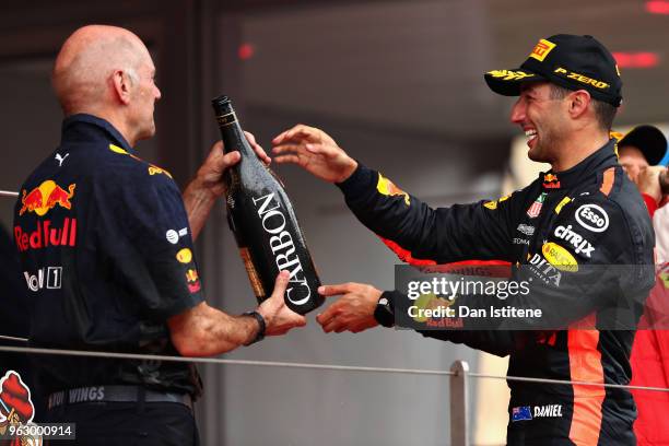 Race winner Daniel Ricciardo of Australia and Red Bull Racing celebrates on the podium with Adrian Newey, the Chief Technical Officer of Red Bull...