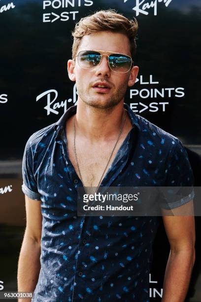In this handout image supplied by Ray-Ban, Jeremy Irvine wearing Ray-Ban poses at the Ray-Ban Studios during All Points East Festival at Victoria...