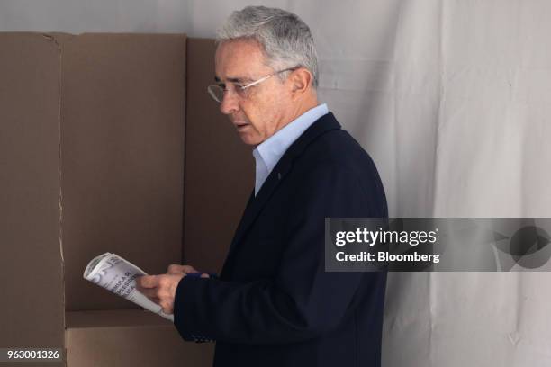 Alvaro Uribe, former president of Colombia, casts his ballot at the National Congress during presidential elections in Bogota, Colombia, on Sunday,...