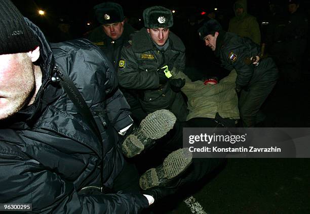 Police officers detain a disabled opposition activist during an unauthorized anti-Kremlin protest January 31, 2010 in downtown Moscow, Russia....
