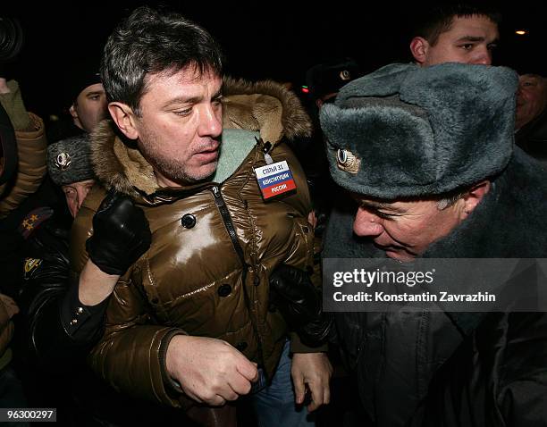 Police officers detain former First Deputy Prime Minister Boris Nemtsov, leader of the opposition group Solidarity, during an unauthorized...