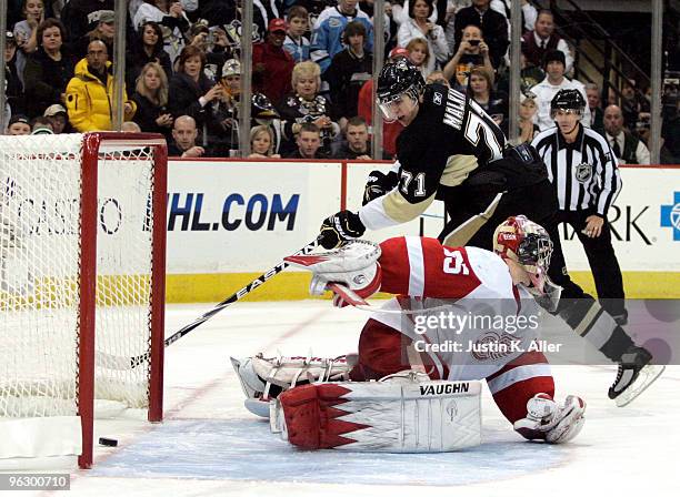 Evgeni Malkin of the Pittsburgh Penguins scores past Jimmy Howard of the Detroit Red Wings to win the game in the shootout at Mellon Arena on January...