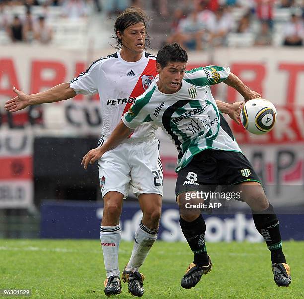 Banfield's footballer James Rodriguez vies for the ball with Matias Almeyda of River Plate during their Argentina first division football match at...