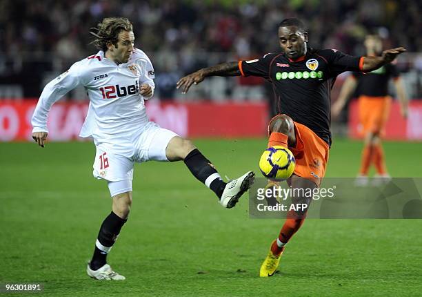 Sevilla's midfielder Diego Capel vies with Valencia's Portuguese defender Miguel Monteiro during a Spanish league football match at Sanchez Pizjuan...
