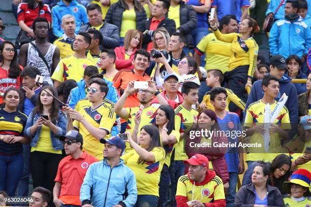 Fans of Colombia cheer their team during a training session open to the public at Nemesio Camacho Stadium. As part of the preparation for FIFA World...