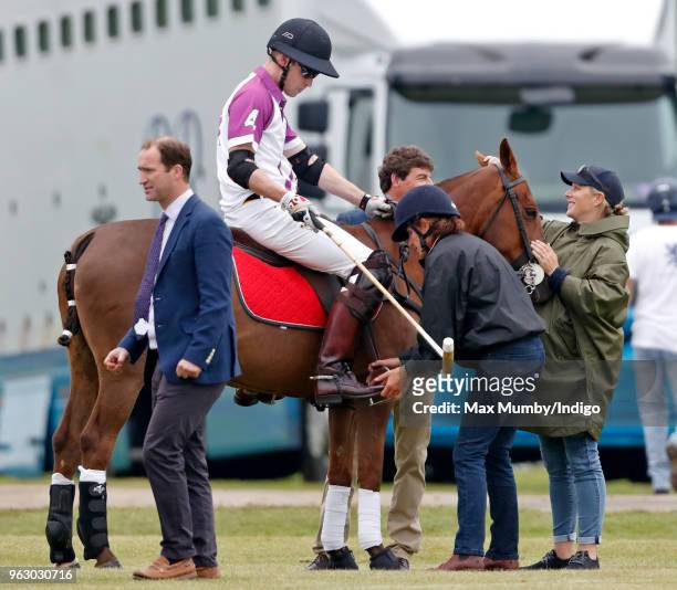 Zara Tindall holds onto her cousin Prince William, Duke of Cambridge's horse as he takes part in the Jerudong Trophy charity polo match at...