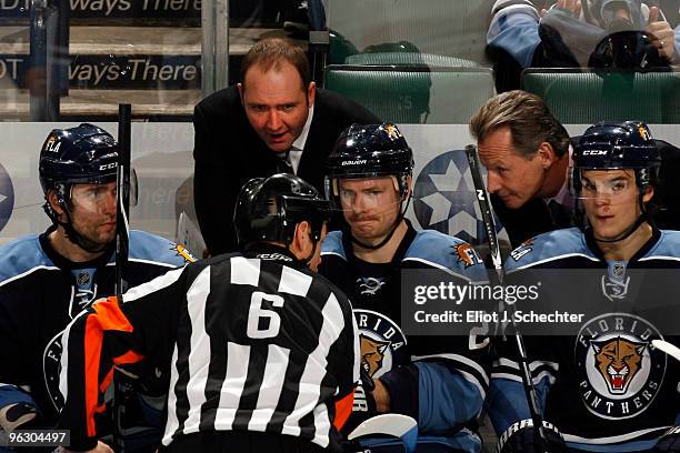 Head Coach Peter DeBoer of the Florida Panthers and Assistant Coach Mike Kitchen discuss the goal review with Referee Dan Marouelli during a break in...