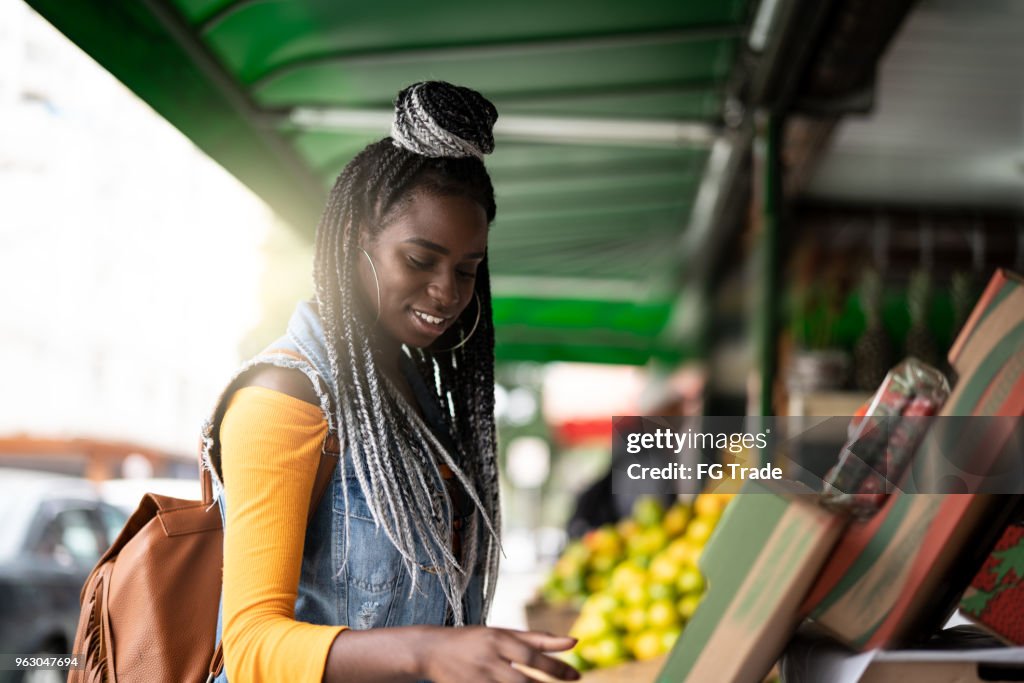 Woman choosing fruits on feira