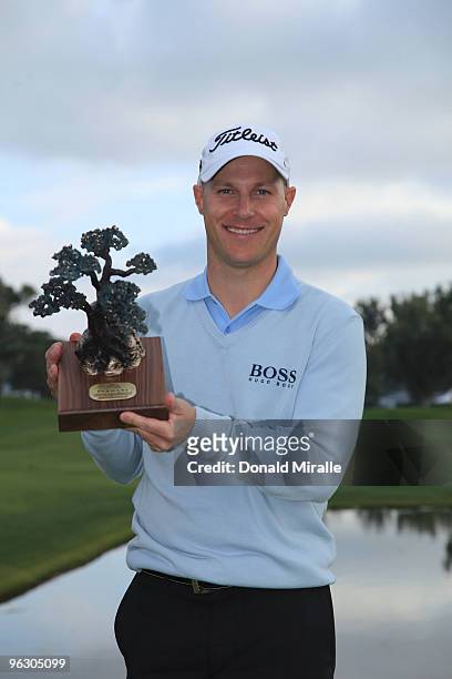 Ben Crane holds the winner's trophy after his -13 under par victory during the final round of the 2010 Farmers Insurance Open on January 31, 2010 at...