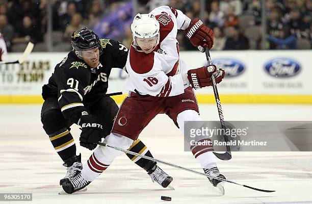 Petr Prucha of the Phoenix Coyotes skates the puck against Brad Richards of the Dallas Stas in the second period at American Airlines Center on...