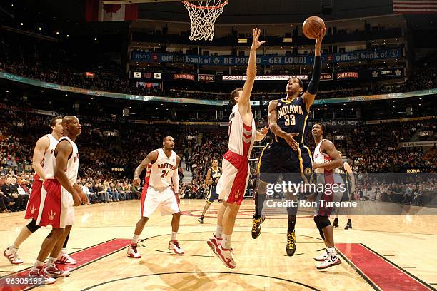 Danny Granger of the Indiana Pacers tries the hookshot in the paint over Andrea Bargnani of the Toronto Raptors during a game on January 31, 2010 at...