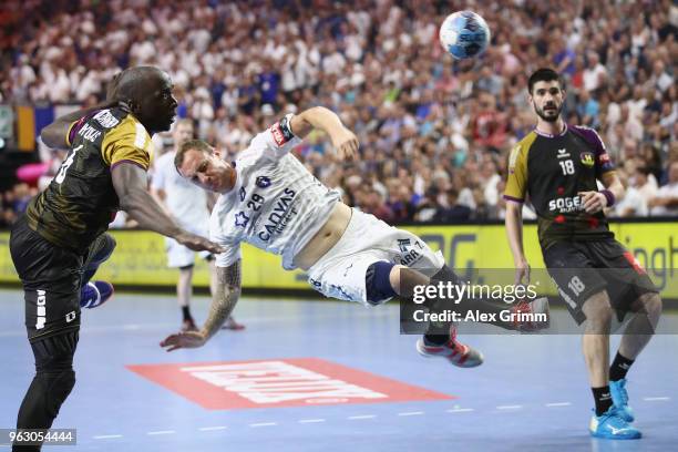 Valentin Porte of Montpellier is challenged by Guy Olivier Nyokas and Eduardo Gurbindo Martinez of Nantes during the EHF Champions League Final 4...