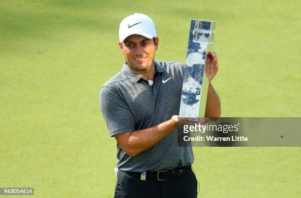 Francesco Molinari of Italy poses with the trophy as he celebrates victory on day four and the final round of the BMW PGA Championship at Wentworth...