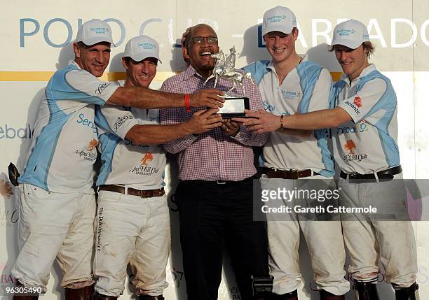 Prince Harry and Prince Seeiso of Lesotho celebrate after the Prince's Sentebale team triumphed against South Africa in the Sentebale Polo Cup on...