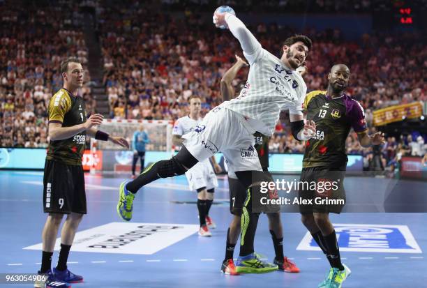 Ludovic Fabregas of Montpellier is challenged by Dominik Klein and Rock Feliho of Nantes during the EHF Champions League Final 4 Final match between...