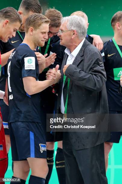 Doktor Hans-Dieter Drewitz, Vice President of German Football Association hands out the gold medal to winner Arne Maier of Berlin after winning 3-1...