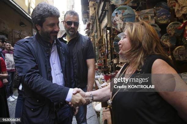 Roberto Fico , President of the Chamber around the Historic Center of Naples and San Gregorio Armeno greets a lady.